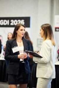 Two professional women networking at the global dating insights conference